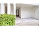 Front entrance featuring neutral tile, well maintained shrubs, leading up to the front door and garage at 273 Madeira Cir, Tierra Verde, FL 33715