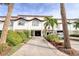 Attractive townhouse with a driveway, lush greenery, and a one car garage adding to its curb appeal at 273 Madeira Cir, Tierra Verde, FL 33715