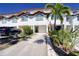 Inviting townhouse with a neutral color palette, lush landscaping, and driveway leading to a private one car garage at 273 Madeira Cir, Tierra Verde, FL 33715