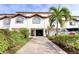 Townhouse with well-maintained landscaping, a private driveway, and a two-car garage at 273 Madeira Cir, Tierra Verde, FL 33715