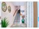 The home's foyer shows the staircase, front door, and decor featuring tiled floors creating an inviting atmosphere at 273 Madeira Cir, Tierra Verde, FL 33715