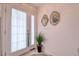 Home entrance displaying tiled floors, adorned with artwork, and an indoor plant creating a welcoming first impression at 273 Madeira Cir, Tierra Verde, FL 33715