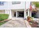 Exterior image of the garage with a view inside featuring a car and door leading to the inside of the home at 273 Madeira Cir, Tierra Verde, FL 33715