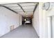 The interior of the single-car garage boasts epoxy floors, white walls, and is long enough for both a car and storage at 273 Madeira Cir, Tierra Verde, FL 33715
