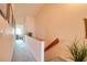 Well-lit hallway with carpet and wood trim, leading to various rooms at 273 Madeira Cir, Tierra Verde, FL 33715