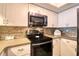 Updated kitchen features stainless steel appliances, mosaic tile backsplash, and granite countertops at 273 Madeira Cir, Tierra Verde, FL 33715