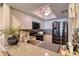 Kitchen features stainless appliances, granite counters, and white cabinets with fan-style ceiling light at 273 Madeira Cir, Tierra Verde, FL 33715