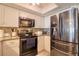 Modern kitchen with stainless appliances, white cabinets, and granite countertops at 273 Madeira Cir, Tierra Verde, FL 33715