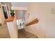 Carpeted staircase with a wooden handrail leading to a bright downstairs entry at 273 Madeira Cir, Tierra Verde, FL 33715