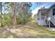 Backyard view of house with grassy area and trees at 3125 Downing St, Clearwater, FL 33759