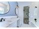 Modern bathroom boasts double sinks, stylish mirrors, and an adjacent bedroom view at 3125 Downing St, Clearwater, FL 33759