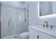 Clean bathroom with a walk-in shower, marble tile, and modern vanity at 3125 Downing St, Clearwater, FL 33759