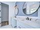 Elegant bathroom with double vanity, quartz countertop, and shiplap accent wall at 3125 Downing St, Clearwater, FL 33759