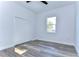 Bedroom with wood-look floors, white shutters and ceiling fan at 3125 Downing St, Clearwater, FL 33759
