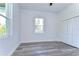 Spacious bedroom with large window, white walls, and wood-look floors at 3125 Downing St, Clearwater, FL 33759