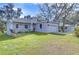 Newly built home features a gray exterior, lush lawn, and a two-car garage at 3125 Downing St, Clearwater, FL 33759