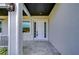 White front door with sidelights, leading to a tiled entryway at 3125 Downing St, Clearwater, FL 33759