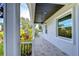 Covered front porch with a ceiling fan and tile flooring at 3125 Downing St, Clearwater, FL 33759