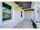 Covered porch with ceiling fan, tile flooring, and a view of the street at 3125 Downing St, Clearwater, FL 33759