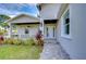 Front porch with gray exterior, white columns, and walkway at 3125 Downing St, Clearwater, FL 33759