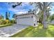 Two-car garage with a gray exterior and paved driveway at 3125 Downing St, Clearwater, FL 33759