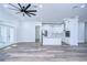 Open concept kitchen with white cabinets and center island at 3125 Downing St, Clearwater, FL 33759
