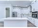 Modern kitchen with white cabinets, stainless steel appliances, and quartz countertops at 3125 Downing St, Clearwater, FL 33759