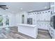 Modern kitchen with white cabinets, stainless steel appliances, and quartz countertops at 3125 Downing St, Clearwater, FL 33759