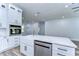 Modern kitchen with white cabinets, stainless steel appliances, and quartz countertops at 3125 Downing St, Clearwater, FL 33759