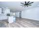 Modern white kitchen features stainless steel appliances and an island at 3125 Downing St, Clearwater, FL 33759