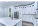 Modern kitchen with white cabinets, stainless steel appliances, and quartz countertops at 3125 Downing St, Clearwater, FL 33759