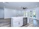 Modern kitchen with white cabinets, stainless steel appliances, and quartz countertops at 3125 Downing St, Clearwater, FL 33759