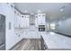 Modern kitchen with white cabinets, stainless steel appliances, and quartz countertops at 3125 Downing St, Clearwater, FL 33759