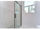 Walk-in shower with marble tile and glass enclosure at 3125 Downing St, Clearwater, FL 33759