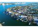 Aerial view of waterfront home with private dock and lush landscaping at 380 Belle Point Dr, St Pete Beach, FL 33706