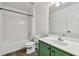 Bathroom with green vanity, white toilet and bathtub at 6213 Venezia Pl, Riverview, FL 33578
