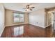 Bedroom with wood floors, ceiling fan and window at 6213 Venezia Pl, Riverview, FL 33578