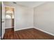 Bedroom with wood floors and door to hallway at 6213 Venezia Pl, Riverview, FL 33578