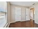 Bedroom with wood floors, window, and two closets at 6213 Venezia Pl, Riverview, FL 33578
