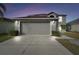 Two-story house with attached garage, landscaping, and driveway at 6213 Venezia Pl, Riverview, FL 33578