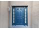 Dark blue front door with sidelights and white lantern at 6213 Venezia Pl, Riverview, FL 33578