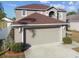 Two-car attached garage with driveway at 6213 Venezia Pl, Riverview, FL 33578