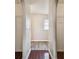 Hallway with wood floors and access to closets at 6213 Venezia Pl, Riverview, FL 33578