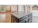 Kitchen island with granite countertop and dark wood cabinets at 6213 Venezia Pl, Riverview, FL 33578
