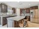 Modern kitchen with granite countertops, stainless steel appliances, and dark wood cabinets at 6213 Venezia Pl, Riverview, FL 33578