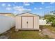 Tan metal storage shed in backyard at 6213 Venezia Pl, Riverview, FL 33578