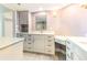 Well-lit bathroom featuring elegant marble countertop, white cabinets, and a full sized mirror at 736 Island Way # 606, Clearwater Beach, FL 33767