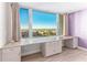 Bedroom with large picture window, built-in desk and storage, and views of the city and water at 736 Island Way # 606, Clearwater Beach, FL 33767