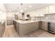 Modern kitchen with a mosaic backsplash, wine cooler, large island, stainless appliances, and pendant lighting at 736 Island Way # 606, Clearwater Beach, FL 33767