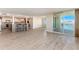 Open floor plan of the living room with view of the kitchen and balcony at 736 Island Way # 606, Clearwater Beach, FL 33767